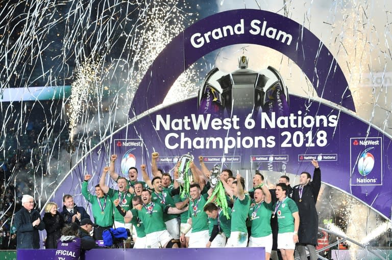 Ireland captain Rory Best holds the Six Nations trophy and fly-half Jonathan Sexton the Triple Crown as players celebrate