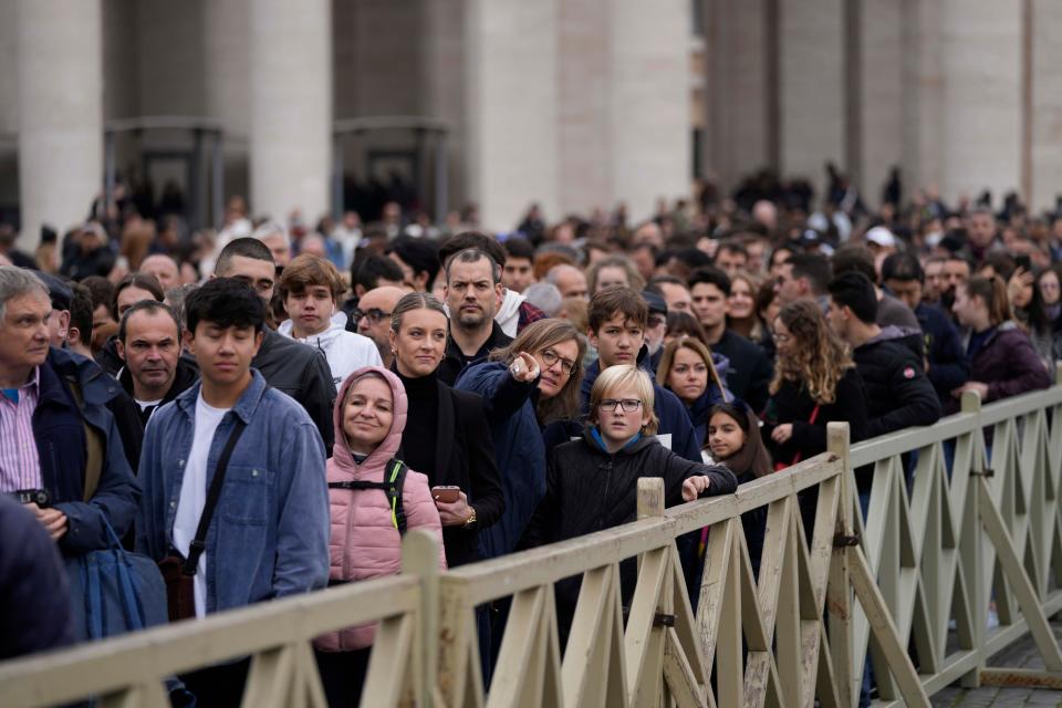 People line up to enter Saint Peter's Basilica at the Vatican where late Pope Benedict 16 is being laid in state at The Vatican, Monday, Jan. 2, 2023. Benedict XVI, the German theologian who will be remembered as the first pope in 600 years to resign, has died, the Vatican announced Saturday. He was 95.