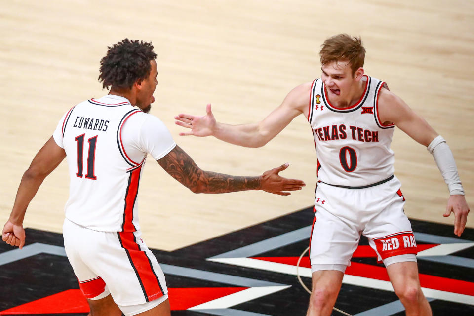 LUBBOCK, TEXAS - FEBRUARY 27: Guard Mac McClung #0 of the Texas Tech Red Raiders high fives Kyler Edwards #11 after making a three-pointer during the first half of the college basketball game against the Texas Longhorns at United Supermarkets Arena on February 27, 2021 in Lubbock, Texas. (Photo by John E. Moore III/Getty Images)