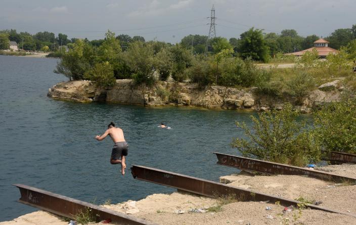 A trespasser jumps into Lake Monroe. Two rescuers were recognized with life-saving awards after saving a quarry jumper who was in distress.