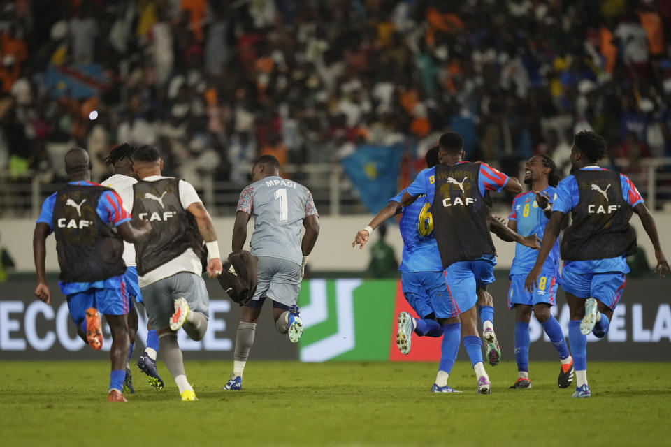 DR Congo players celebrate after DR Congo's goalkeeper Lionel Mpasi, centre left, scored the winning goal in a penalty shootout winning 8-7 during the African Cup of Nations Round of 16 soccer match between Egypt and DR Congo, at the Laurent Pokou stadium in San Pedro, Ivory Coast, Sunday, Jan. 28, 2024. 2024. (AP Photo/Sunday Alamba)