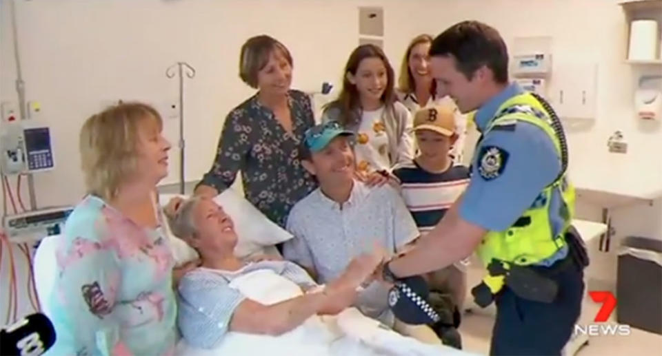 Patricia Byrne received a visit from one of her rescuers officer Steven Ball, with her family at her bedside. Source: 7 News