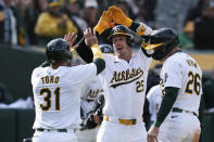 Oakland Athletics' Brent Rooker (25) celebrates with Abraham Toro (31) and Tyler Nevin (26) after hitting a three-run home run against the Miami Marlins during the third inning of a baseball game Saturday, May 4, 2024, in Oakland, Calif. (AP Photo/Godofredo A. Vásquez)