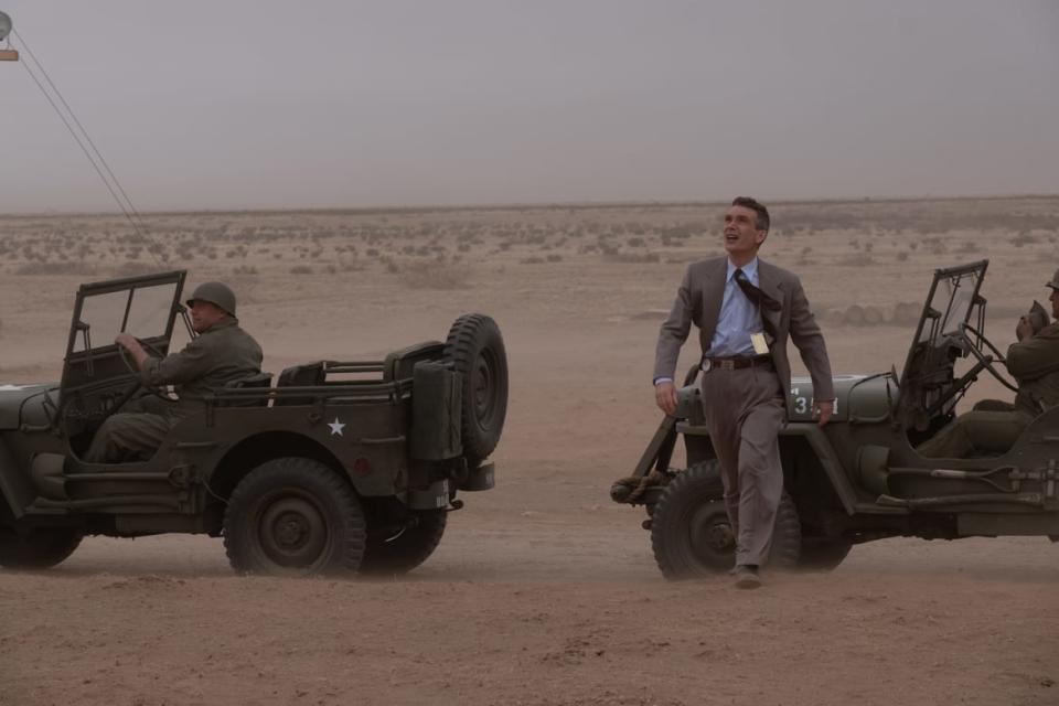 Cillian Murphy as J. Robert Oppenheimer walks at the atomic bomb test site.