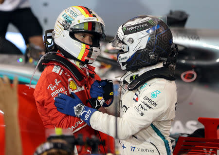 Formula 1 F1 - Bahrain Grand Prix - Bahrain International Circuit, Sakhir, Bahrain - April 8, 2018 Ferrari's Sebastian Vettel and Mercedes' Valtteri Bottas after the race REUTERS/Ahmed Jadallah