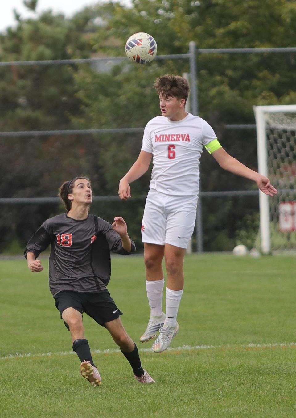Minerva's Nathanial Frankford leaps for the ball during a game against Marlington this season.