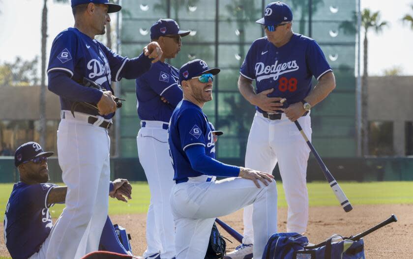 Dodgers first baseman Freddie Freeman, front, looks on with Jason Hayward, Dino Ebel, manager Dave Roberts and Bob Geren.