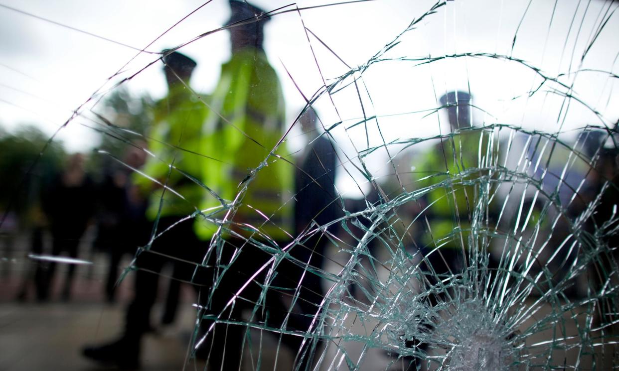 <span>Greater Manchester police assess the damage after the disturbances in Salford.</span><span>Photograph: Christopher Thomond/The Guardian</span>