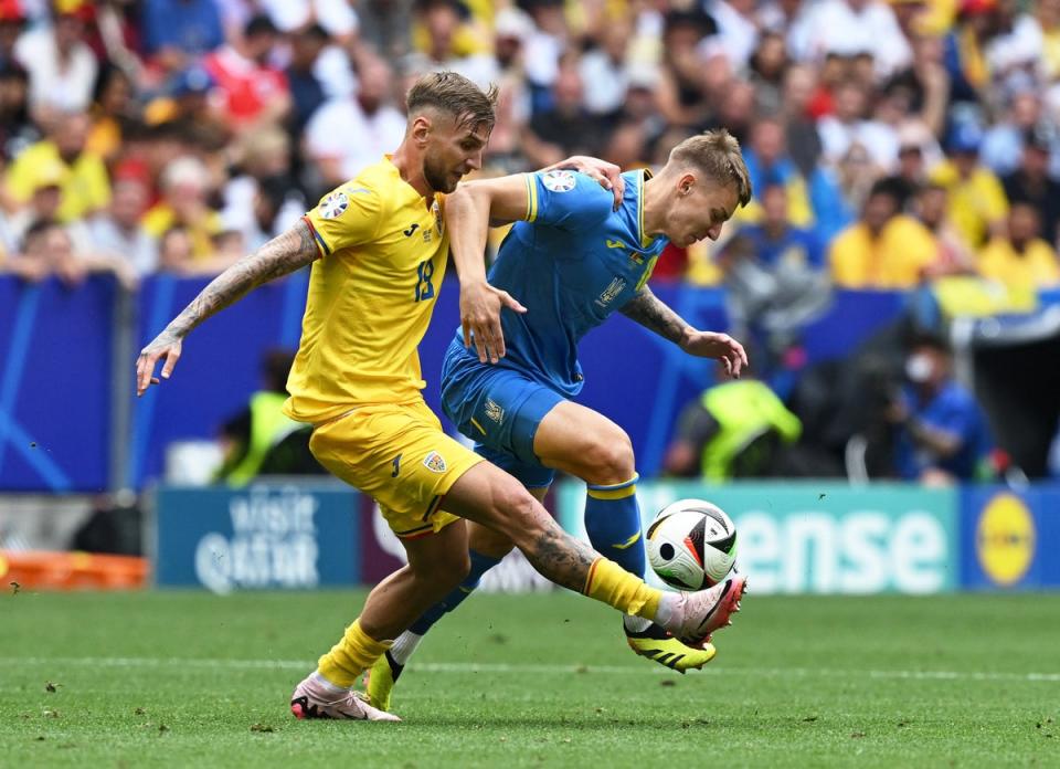 Romania’s Denis Dragus in action with Ukraine’s Volodymyr Brazhko (Reuters)