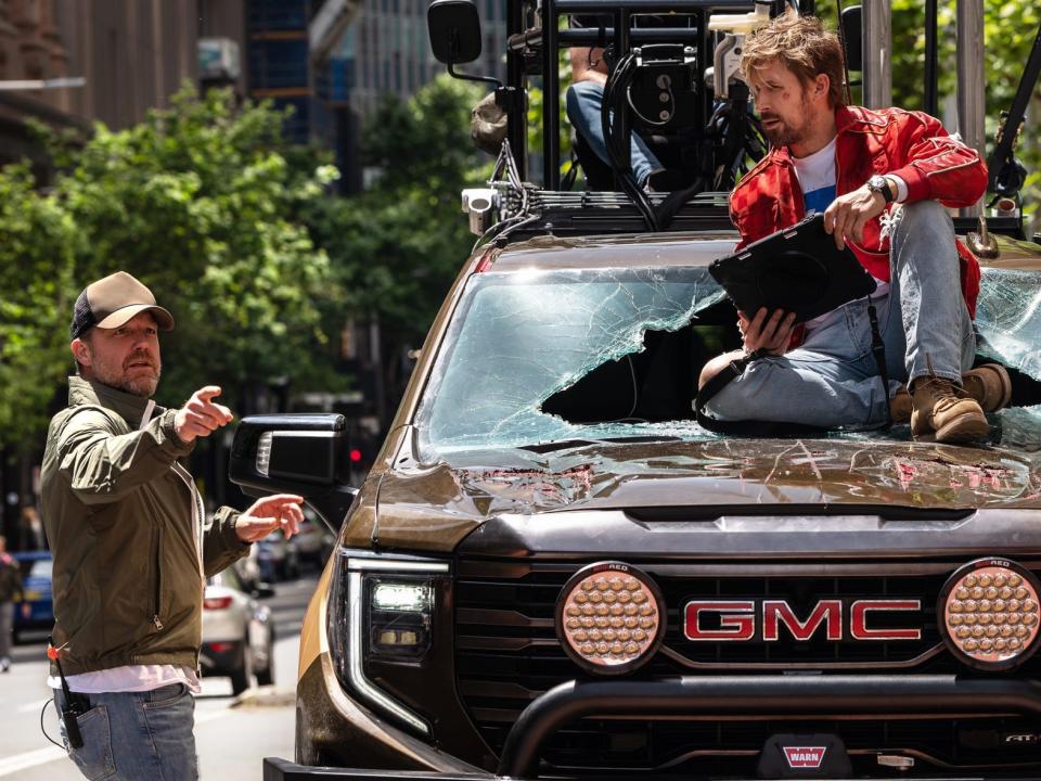 David Leitch directing Ryan Gosling in the hood of a truck