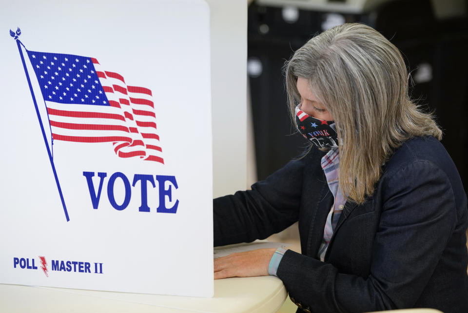 Republican Senate candidate Sen. Joni Ernst fills out her ballot at Red Oak First Christian Church Tuesday, Nov. 3, 2020, in Red Oak, Iowa. (AP Photo/Charlie Neibergall)