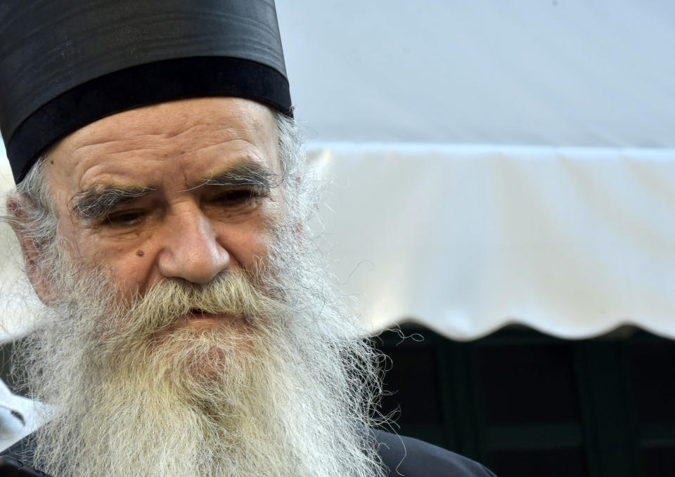 Serbian Orthodox bishop Amfilohije addresses the media after voting at a polling station in Cetinje, Montenegro, Sunday, Aug. 30, 2020. Voters in Montenegro on Sunday cast ballots in a tense election that is pitting the long-ruling pro-Western party against the opposition seeking closer ties with Serbia and Russia. (AP Photo/Risto Bozovic)