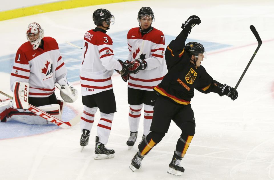 Germany's Ziegler celebrates his goal on Canada's goalie Paterson as Canada's Bigras and Morrissey react during the first period of their IIHF World Junior Championship ice hockey game in Malmo