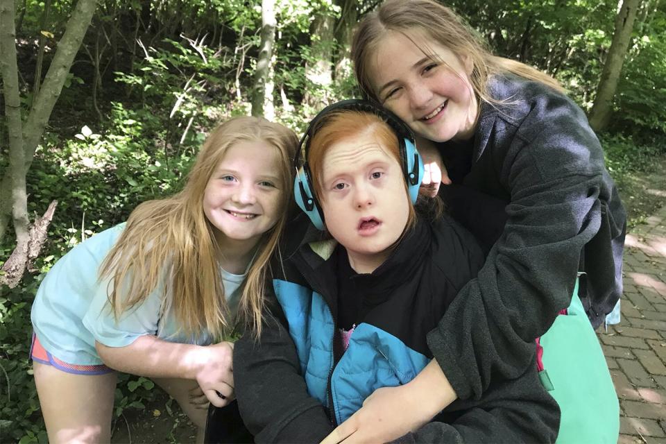 Raegan and Rylyn Richiins paint "Be Kind" signs. LaGrange, KY. Kids are : Kendall is the red-head, who passed away. Leena has dark-hair and Down syndrome. Liam is the cute boy, Raegan is older, with brownish hair. Rylyn is younger, with blonde hair. "Our last outing with Kendall, May 30th, 2021. We packed up her wheelchair, and we loaded up 2 cars (because we all couldn't fit in the convertible). We HAD TO take our VW Bug, because Kendall loved that car! I think it was because she loved the wind blowing through her bright red hair...I know I loved seeing her in that car! We went on a trail hike at the local park near our home, called Anchorage Trail. The day was perfect! Not too hot, not too cold, and the air was surprisingly crisp, which not common here in Kentucky, in May?!? Very special day for us. Credit: Courtesy Rhonda Richins