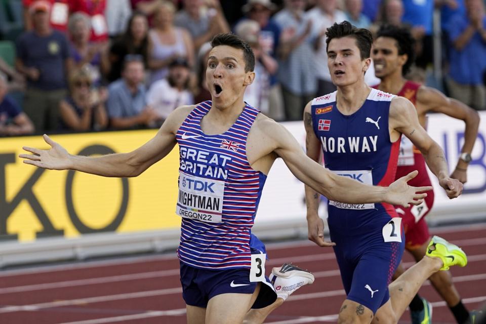 Jake Wightman makes an exultant face as he crosses the finish line.