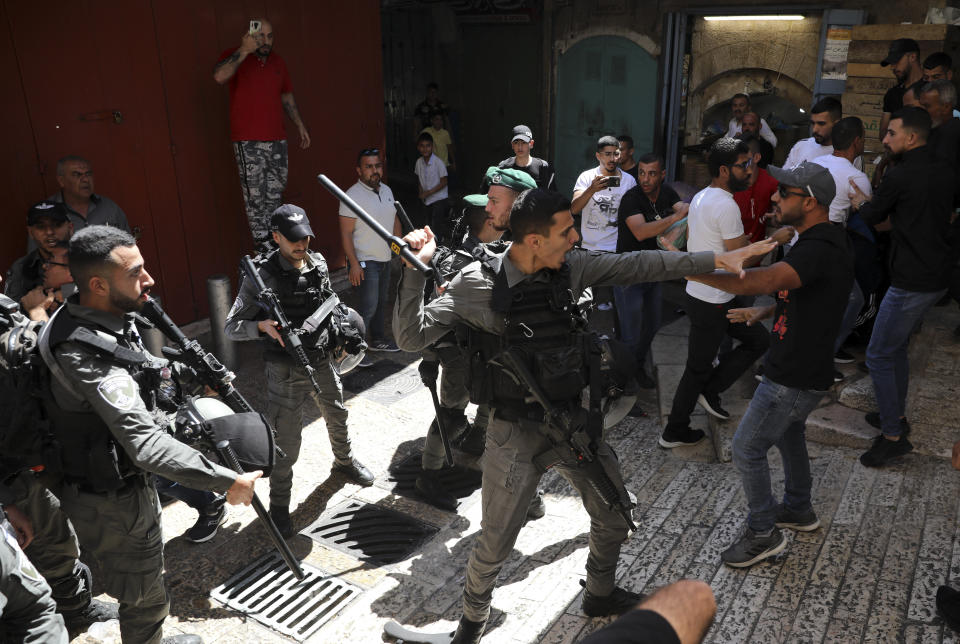 Israeli police and Palestinian protesters clash in Jerusalem's Old City, Tuesday, May 18, 2021. (AP Photo/Mahmoud Illean)