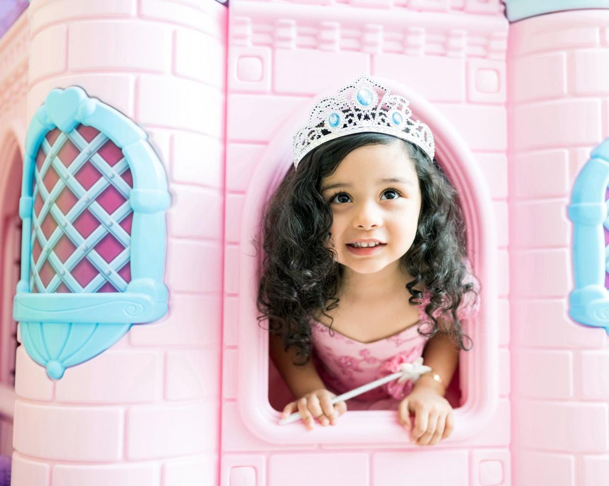 child in pink playhouse