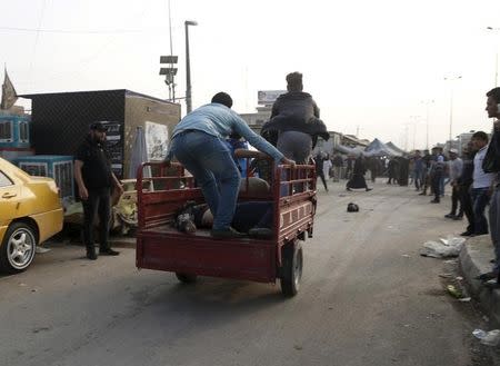 People transport wounded after suicide blasts in Baghdad's Sadr City February 28, 2016. REUTERS/Wissm al-Okili