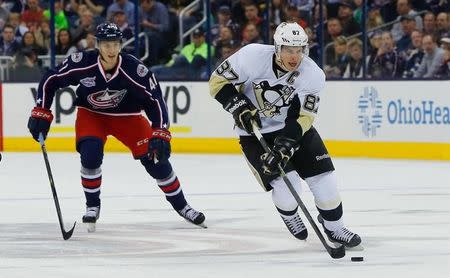 Pittsburgh Penguins center Sidney Crosby (87) carries the puck as Columbus Blue Jackets center Alexander Wennberg (41) trails the play during the first period at Nationwide Arena. Mandatory Credit: Russell LaBounty-USA TODAY Sports