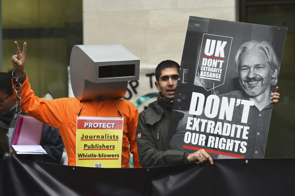 Supporters of Wikileaks founder Julian Assange demonstrate oustide Westminster Magistrates' Court in London where Assange is expected to appear as he fights extradition to the United States on charges of conspiring to hack into a Pentagon computer, in London, Monday, Oct, 21, 2019. U.S. authorities accuse Assange of scheming with former Army intelligence analyst Chelsea Manning to break a password for a classified government computer. (Kirsty O'Connor/PA via AP)