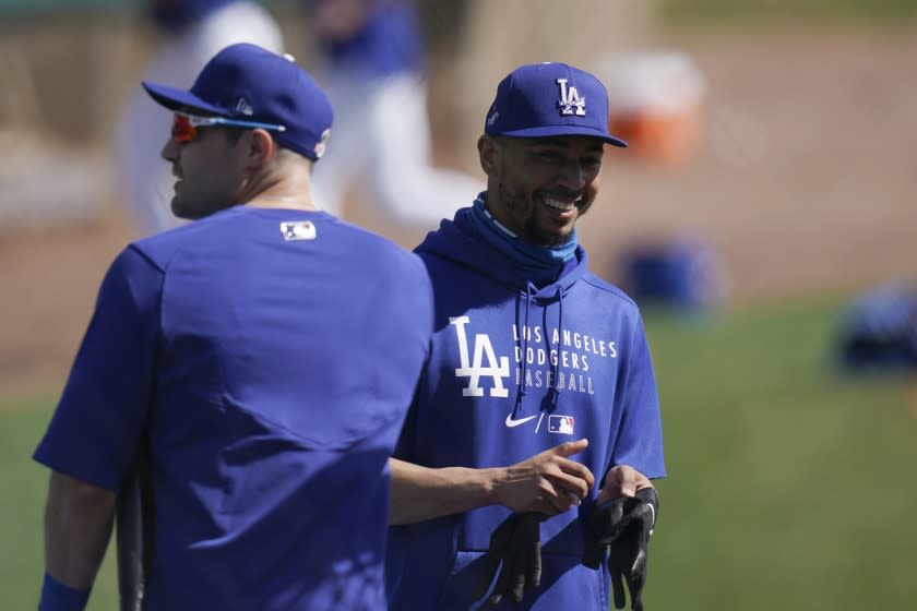 Los Angeles Dodgers' Mookie Betts, right, and A.J. Pollock, left.