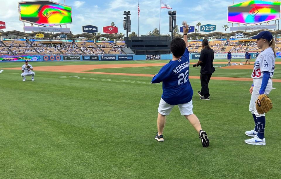 Palm Springs resident Denise Goolsby warms up Thursday before throwing out the first pitch at Dodger Stadium.