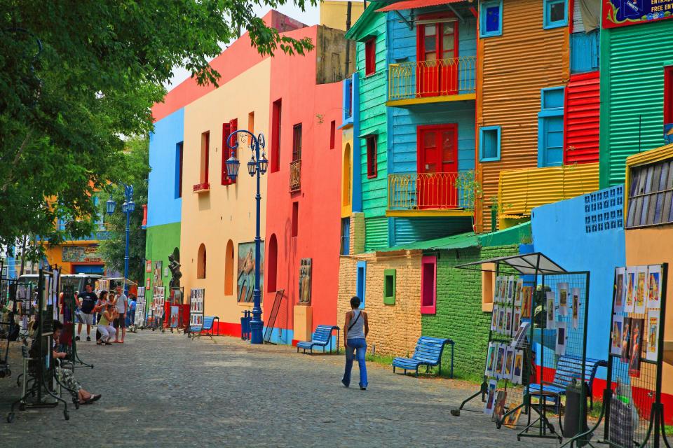 The multicolor homes that line the La Boca neighborhood of Buenos Aires, Argentina, still reflect much of their late-19th-century history. When European immigrants arrived from the Italian city of Genoa, many of them became dockworkers, who, with little to no disposable income, built their homes with thin pieces of corrugated sheet metal from the docks, coated with leftover paint. When one color inevitably ran out, they would simply use another one. And thus a colorful neighborhood was born. Today, Caminito (shown) is brought to life by an artist's re-creation of the old tenement dwellings that used to line La Boca's streets.