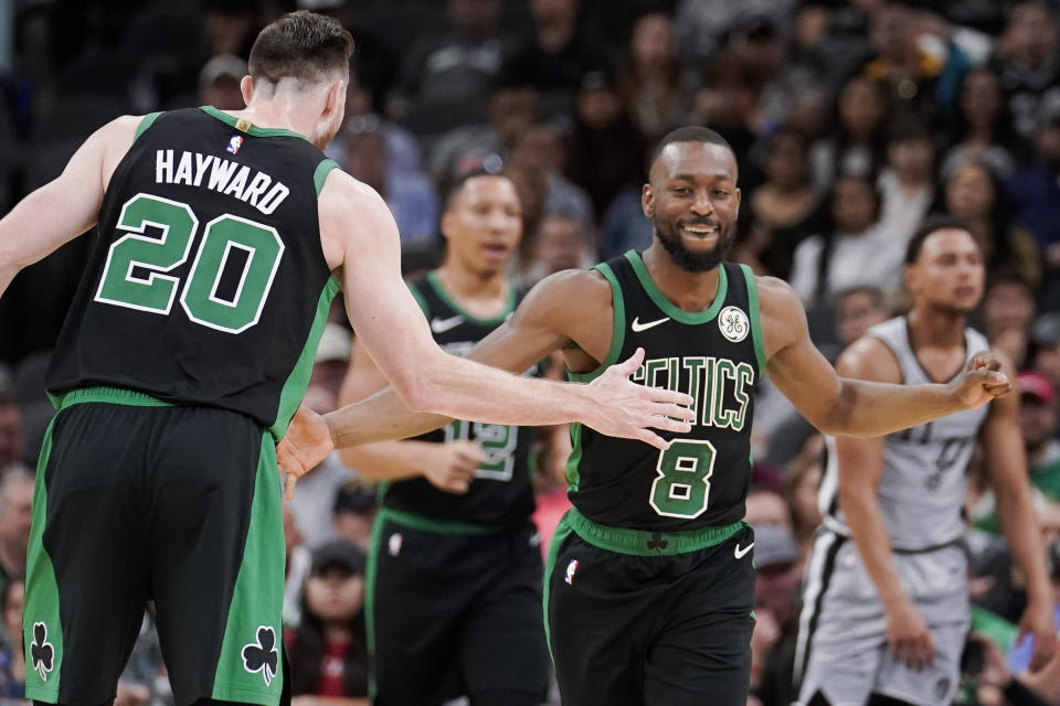 Boston Celtics' Kemba Walker (8) and Gordon Hayward celebrate a basket during the first half of an NBA basketball game against the San Antonio Spurs, Saturday, Nov. 9, 2019, in San Antonio. (AP Photo/Darren Abate)