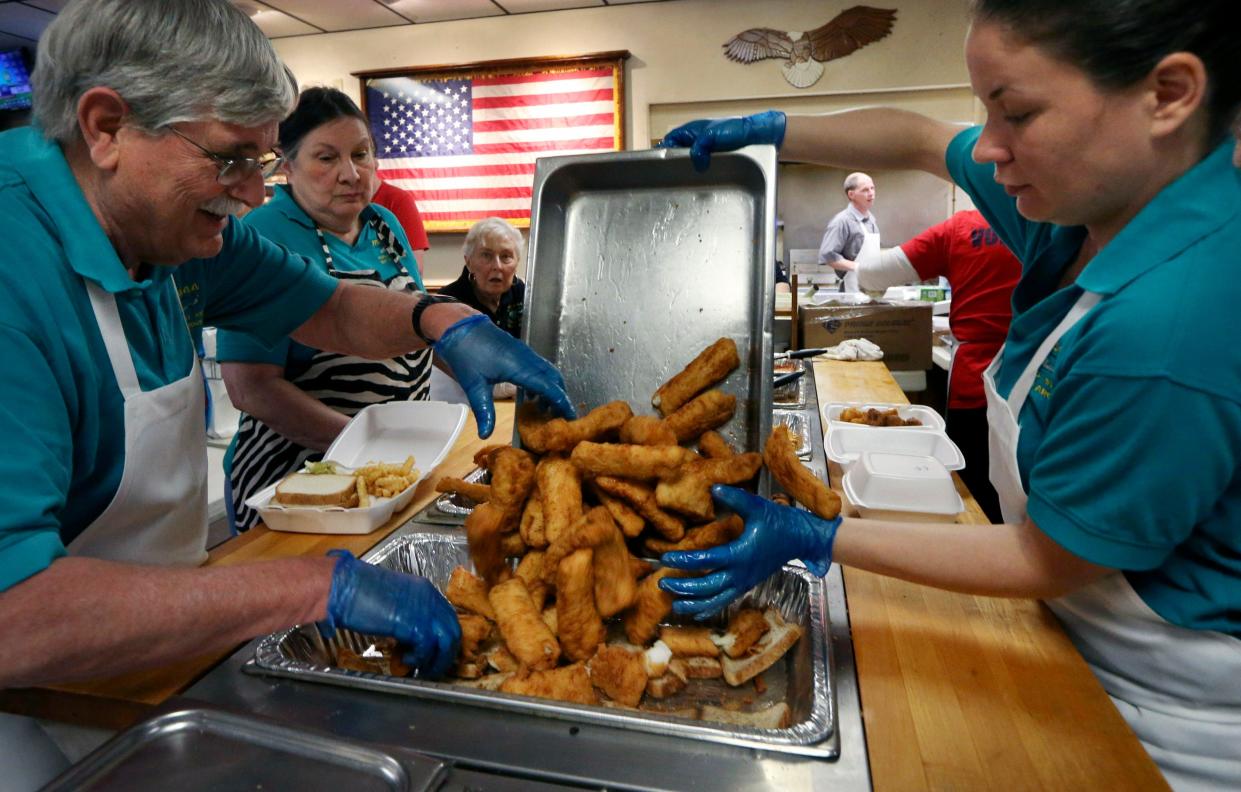 Volunteer Rodney Ford, who replenishes the cod with help from Tanya Myers for the lunch crowd at a fish fry on Friday, April 19, 2019, at the VFW Post 3944 in Overland, Mo. Fish fries are common on Fridays during Lent.