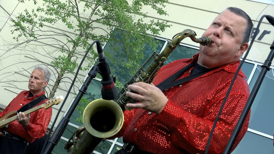 Steve Barlotta performs on the saxophone with the Sensational Soul Cruisers outside CentraState's Star and Barry Tobias Ambulatory Campus in Freehold Township, N.J., on Wednesday evening. Barlotta credits hospital staff for saving his life in 2020, when he was on a ventilator for 24 days and later had to relearn how to move again.