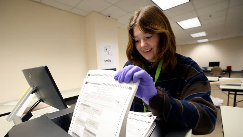 Maggie Brunner, temporary election worker, scans ballots at the Salt Lake County Government Center in Salt Lake City on Wednesday, June 26, 2024.