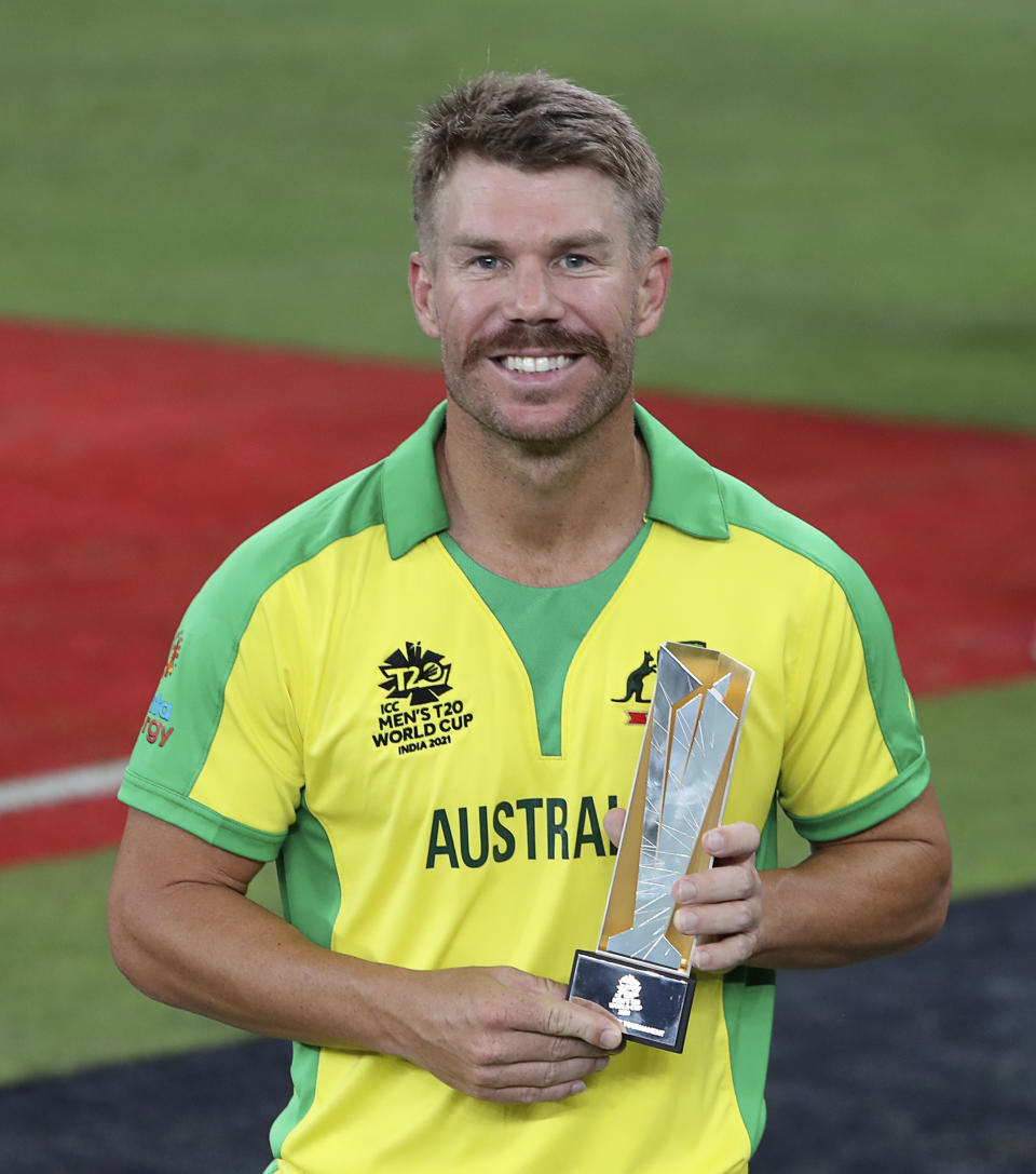 Australia's David Warner poses with his Man of the Tournament award after the Cricket Twenty20 World Cup final match between New Zealand and Australia in Dubai, UAE, Sunday, Nov. 14, 2021. (AP Photo/Aijaz Rahi)