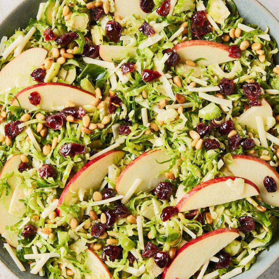 apple cranberry brussel sprout salad in a white bowl