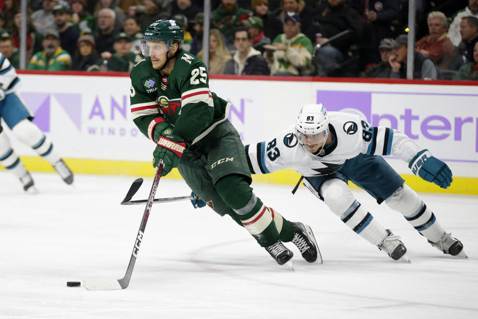 Minnesota Wild defenseman Jonas Brodin (25) controls the puck in front of San Jose Sharks left wing Matt Nieto (83) in the second period of an NHL hockey game Sunday, Nov. 13, 2022, in St. Paul, Minn. (AP Photo/Andy Clayton-King)