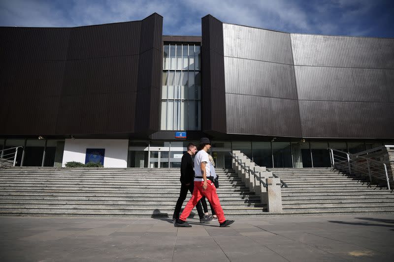 People walk in front of the Polish Central Bank (NBP) building in Warsaw