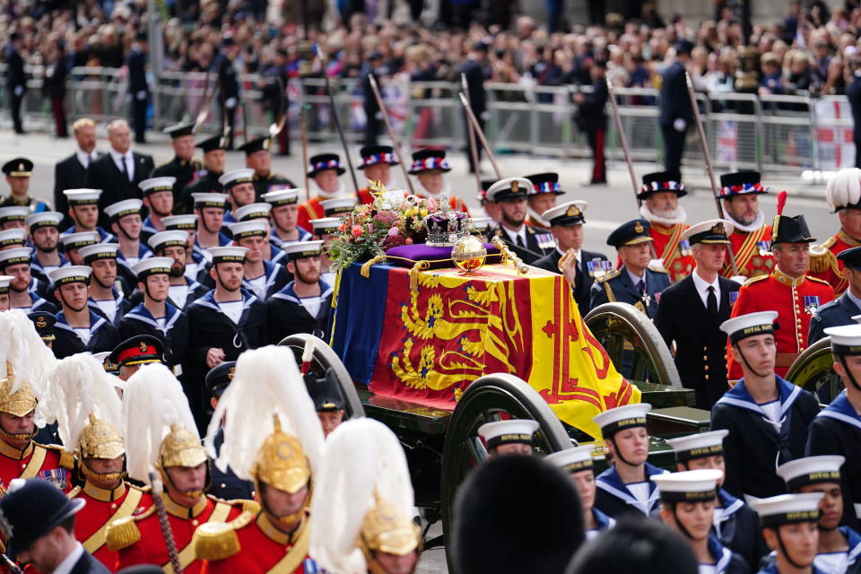 The coffin of Queen Elizabeth II is pulled past Horse Guards Avenue following her funeral service in Westminster Abbey in central London Monday Sept. 19, 2022. The Queen, who died aged 96 on Sept. 8, will be buried at Windsor alongside her late husband, Prince Philip, who died last year. (David Davies/Pool Photo via AP)