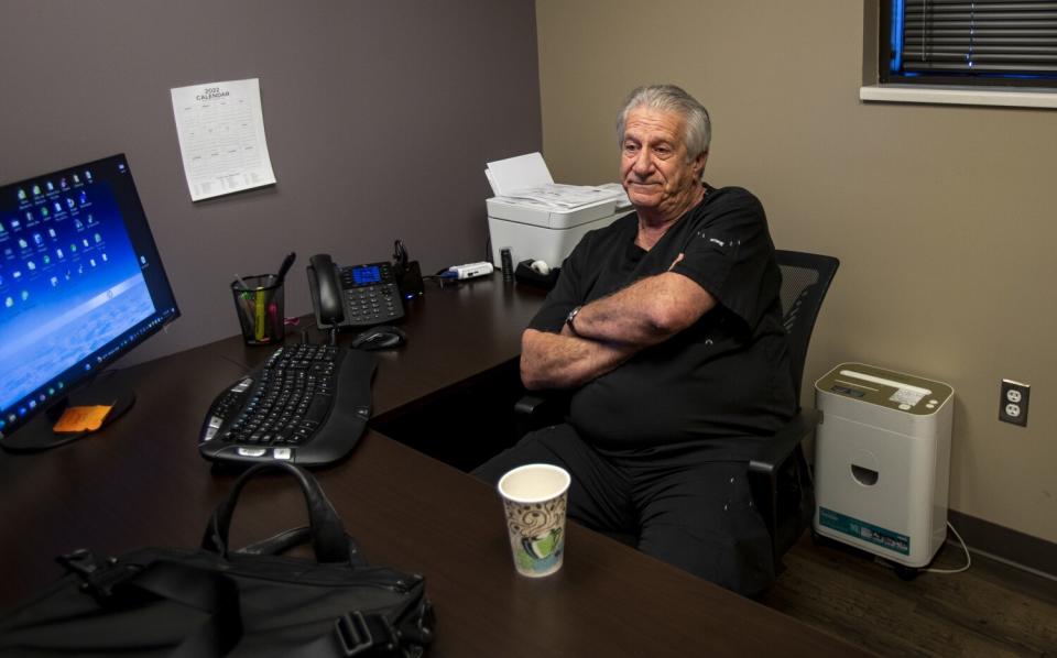 Man sits in his office.