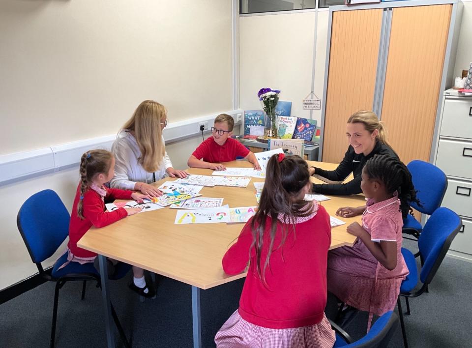 Pupils and teachers with their drawings