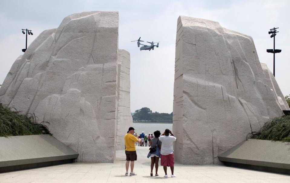 A Osprey military helicopter flies by the Martin Luther King Jr. Memorial in Washington, Tuesday, Aug. 27, 2013. Barack Obama, who will speak, was 2 years old and growing up in Hawaii when Martin Luther King Jr. delivered his “I Have a Dream” speech from the steps of the Lincoln Memorial. Fifty years later, the nation’s first black president will stand as the most high-profile example of the racial progress King espoused, delivering remarks at a nationwide commemoration of the 1963 demonstration for jobs, economic justice and racial equality. (AP Photo/Carolyn Kaster)