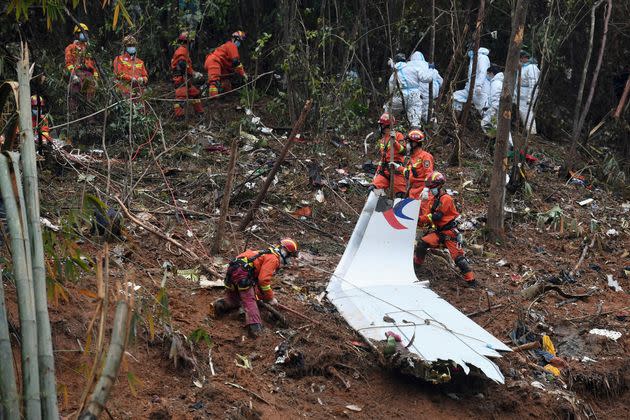 Search-and-rescue workers search through debris at the China Eastern flight crash site on March 24. (Photo: Lu Boan/Xinhua News Agency via Associated Press)