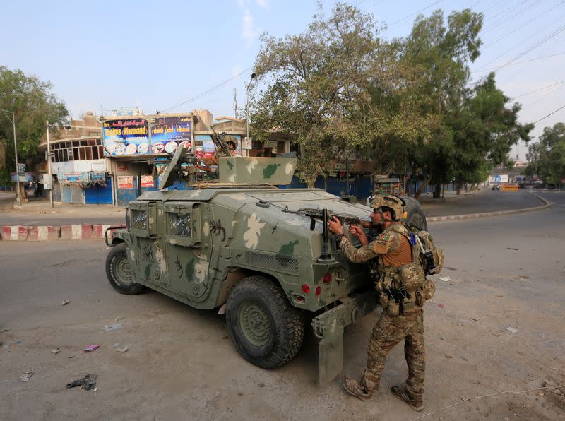 Afghan security forces keep watch near the site of an attack on a jail compound in Jalalabad