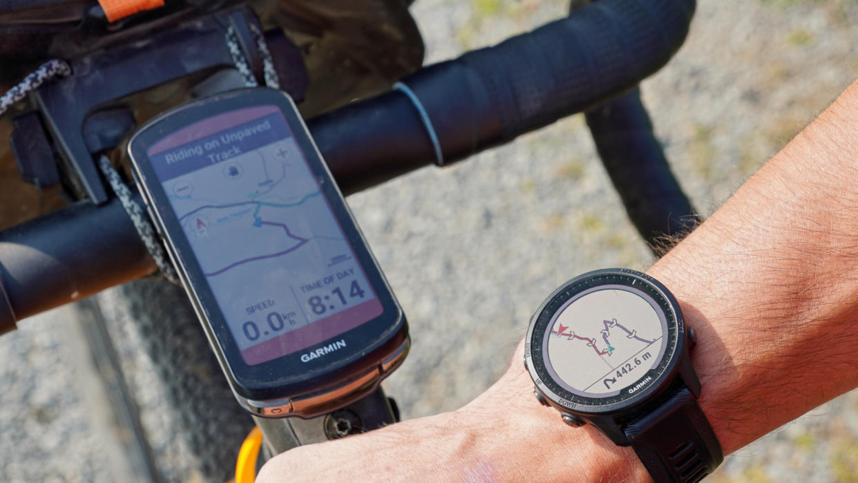  Garmin Forerunner 955 Solar smartwatch on a cyclists' wrist and a Garmin Edge 1040 Solar cycling computer mounted on the handlebars of a gravel bike 