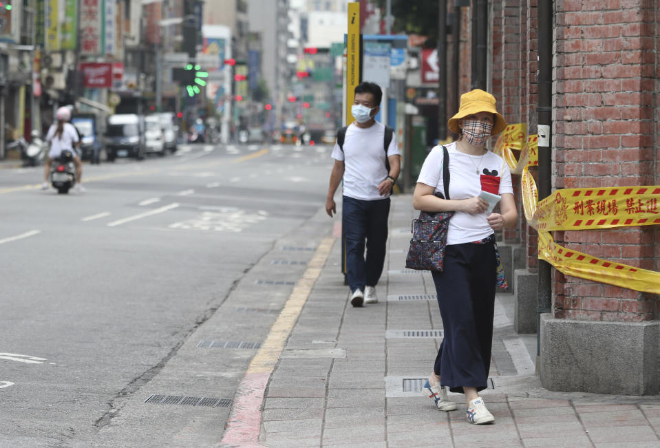 People wear face masks to help protect against the spread of the coronavirus after the COVID-19 alert rose to level 3 in Taipei, Taiwan, Tuesday, May 18, 2021. (AP Photo/Chiang Ying-ying)