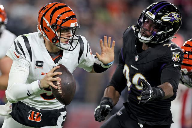 <p>Patrick Smith/Getty</p> Joe Burrow scrambles during Thursday's game against the Ravens