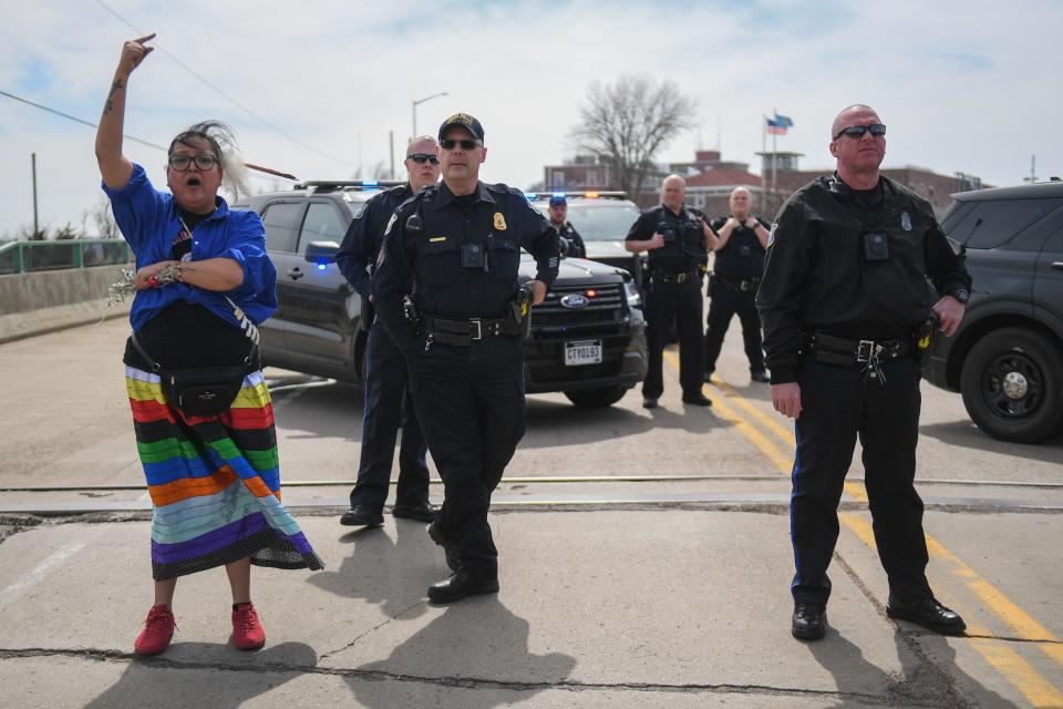 Allison Renville speaks to the crowd about Sioux Falls police not letting them pass on the bridge leading up to the state penitentiary on Friday, April 5, 2024, on North Drive in Sioux Falls.