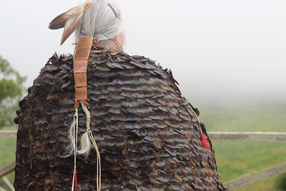 Julia Marden, a member of the Gay Head (Aquinnah) Wampanoag Tribe, wears a turkey feather mantle, which she revealed during a powwow on Sept. 6, 2023.