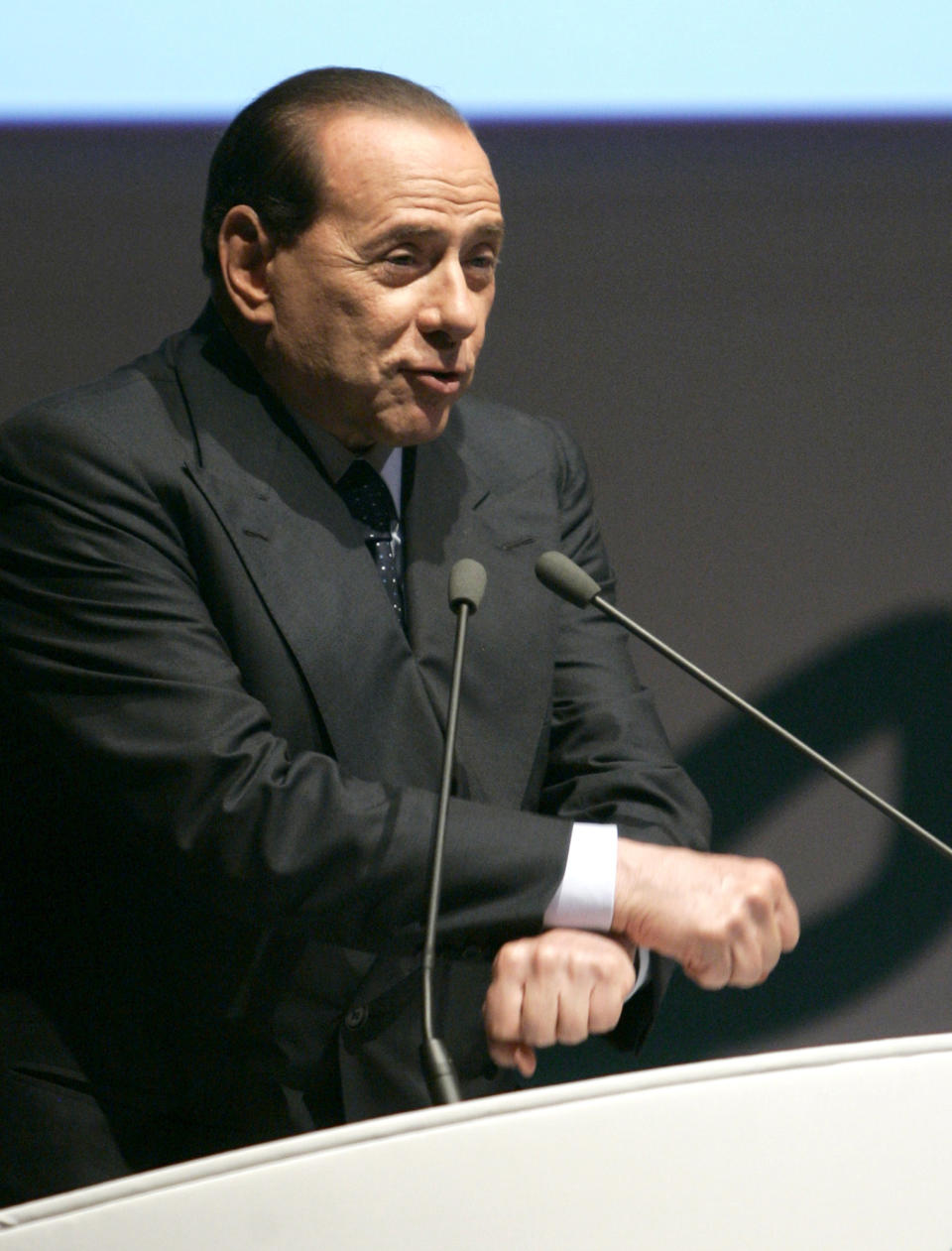 FILE -- In this file photo taken on June 25, 2008, Silvio Berlusconi, then Italian Premier, gestures miming handcuffs as he speaks during the Confesercenti traders association's annual assembly in Rome. Just when Silvio Berlusoni hopes to run for office after being sidelined for a tax-fraud conviction, a Milan judge has ordered him to be tried on corruption charges. (AP Photo/Riccardo De Luca)