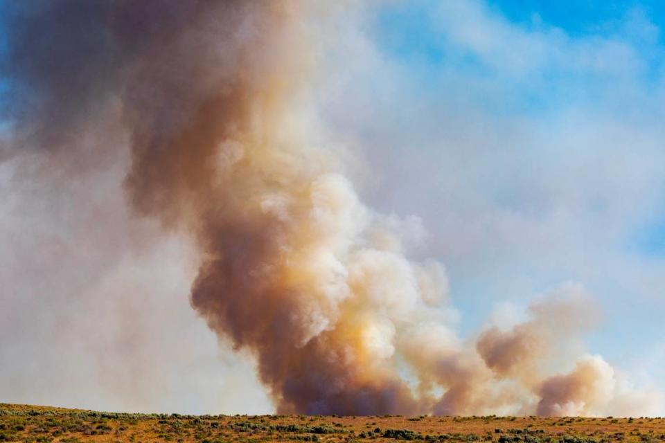 A vegetation fire retardant burns east of Blacks Creek Road south of Interstate 84, Wednesday, June 21, 2023.