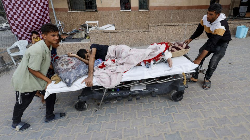 Ali Abu Ismehan, a wounded Palestinian evacuated from the Gaza European Hospital after the Israeli military ordered residents to leave neighborhoods in the eastern part of Khan Younis, is wheeled on a bed at Nasser hospital, also in Khan Younis, on Monday. - Mohammed Salem/Reuters