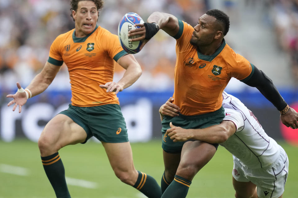Australia's Samu Kerevi passes the ball during the Rugby World Cup Pool C match between Australia and Georgia at the Stade de France in Saint-Denis, north of Paris, Saturday, Sept. 9, 2023. (AP Photo/Christophe Ena)